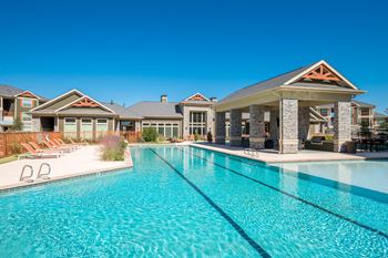 Expansive resort style pool and custom fountain, lounge deck, and cabanas